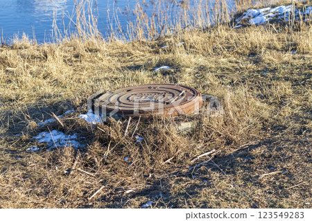 Manhole on the frozen ground 123549283