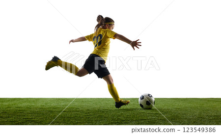 Competitive and concentrated teen girl, soccer player in yellow jersey and black shirts in motion kicking ball against white studio background Competitive and concentrated teen girl, soccer player in yellow jersey and black shirts in motion kicking ball against white studio background 123549386