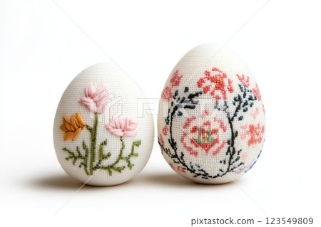 Stitch embroidered Easter eggs isolated on white background featuring intricate floral designs and vibrant colors 123549809