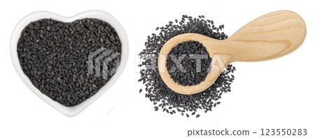 black sesame seeds in ceramic bowl and wooden spoon isolated on white background. Top view. Flat lay black sesame seeds in ceramic bowl and wooden spoon isolated on white background. Top view. Flat lay 123550283