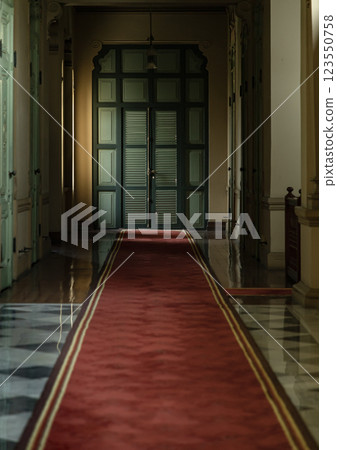 Perspective hallway leading into green wooden door inside The main Bang Khun Phrom Palace. 123550758