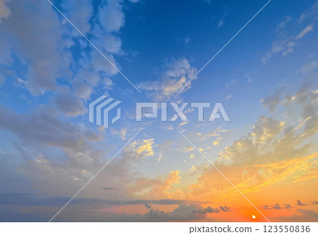 Weather background, sky with clouds. Blue summer sky background with sunset sun 123550836