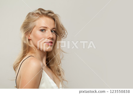 Attractive blond model woman portrait. Beautiful face with healthy clear skin, long shiny hair  123550838
