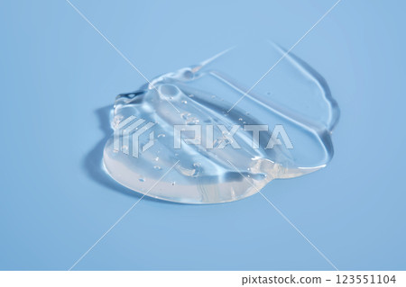 The texture of a cosmetic gel on a blue background. The texture of a cosmetic gel on a blue background. 123551104
