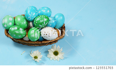 Decorated golden eggs on a trendy blue background. Minimal holiday concept. Happy Easter background, place for text, postcard, banner for the screen. 123551703