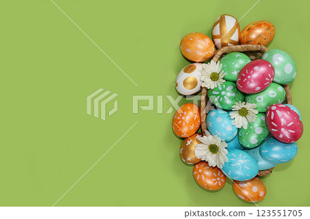 Decorated golden and blue eggs on a trendy green background. Minimal holiday concept. Happy Easter background, place for text, postcard, banner for the screen. Decorated golden and blue eggs on a trendy green background. Minimal holiday concept. Happy Easter background, place for text, postcard, banner for the screen. 123551705
