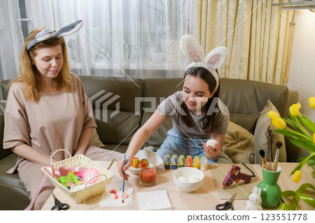 Mother And Daughter Painting Easter Eggs Together. Mother And Daughter Painting Easter Eggs Together. 123551778