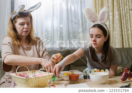 Mother And Daughter Decorating Easter Eggs At Home. Mother And Daughter Decorating Easter Eggs At Home. 123551784