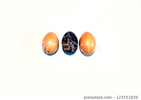 Decorated golden Easter eggs on a light background. Holiday minimal concept, postcard, Happy Easter concept, background. Creative painting eggs at home, idea of simple drawings for coloring, Decorated golden Easter eggs on a light background. Holiday minimal concept, postcard, Happy Easter concept, background. Creative painting eggs at home, idea of simple drawings for coloring, 123551839