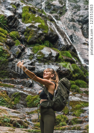 Woman Tourist Taking Selfie Picture near Waterfall Woman Tourist Taking Selfie Picture near Waterfall 123551983