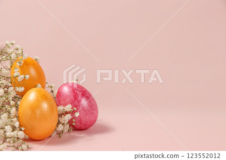 Decorated golden easter eggs on a pink background. Minimal holiday concept. Happy easter background. Creative painting of eggs at home, the idea of simple drawings for coloring, a place for text, a 123552012