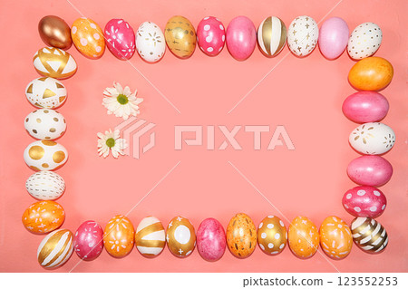 Decorated golden and pink eggs on a trendy pastel background. Minimal holiday concept. Happy Easter background, place for text, postcard, banner for the screen. 123552253