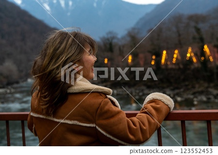 Woman Mountains Festival Lights: Autumnal evening view, enjoying illuminated celebration near river. Woman Mountains Festival Lights: Autumnal evening view, enjoying illuminated celebration near river. 123552453