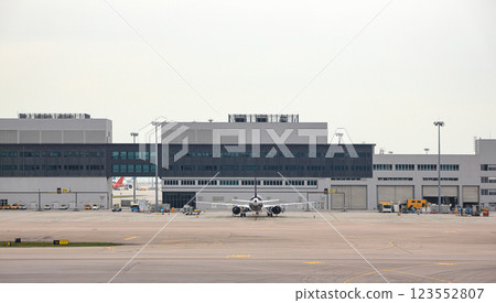 Airplane parking at parking bay. Service passengers by bus from bus gate. Airplane parking at parking bay. Service passengers by bus from bus gate. 123552807