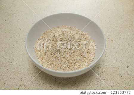 a bowl of still-dry oatmeal sat 123553772
