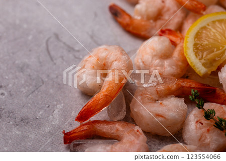 Frozen uncooked prawns or shrimps with lemon Frozen uncooked prawns or shrimps with lemon 123554066