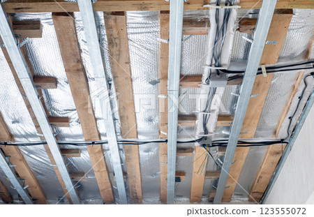 Installation of ceiling with electrical wiring. Installation of ceiling with electrical wiring. 123555072