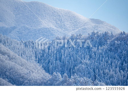 Snowy mountains against the blue sky 123555926