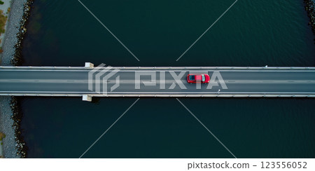 A passenger car drives over a connecting road over a bridge over water on the coast, coastal road by the sea - ai generated 123556052