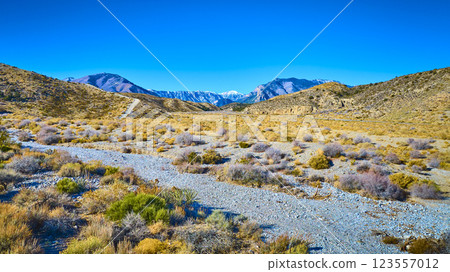 Aerial of Nevada Desert Path with Snow-Capped Mountains Aerial of Nevada Desert Path with Snow-Capped Mountains 123557012