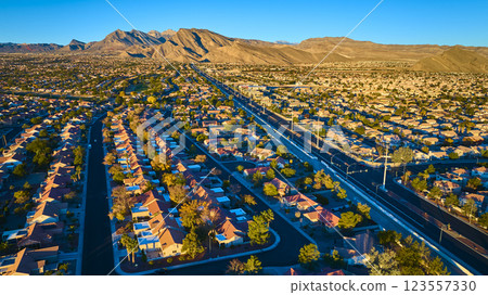 Aerial of Desert Suburb and Mountains at Golden Hour 123557330