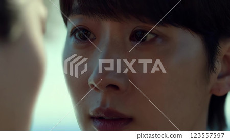 Young man looking at someone out of focus 123557597