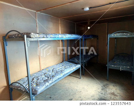 Bunk Beds Arranged in a Compact Living Space With Simple Decor and Practical Design 123557643