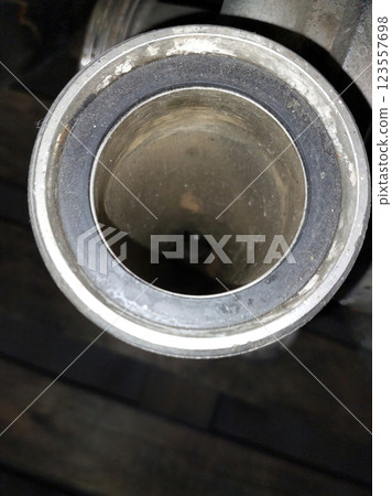 Exploring the Intricate Design of a Stainless Steel Pipe Fitting in a Workshop Setting Exploring the Intricate Design of a Stainless Steel Pipe Fitting in a Workshop Setting 123557698