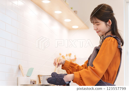 A woman who cooks in the kitchen 123557799