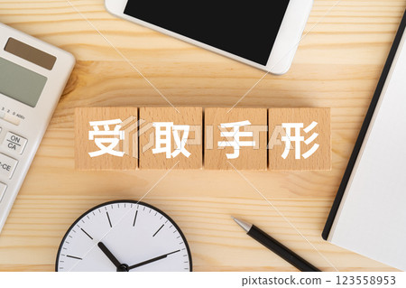 Blocks with the word "receivable" written on them, a calculator, and a smartphone 123558953