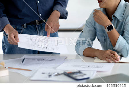Architect or engineer is looking at and checking the details of the building Architect or engineer is looking at and checking the details of the building 123559615