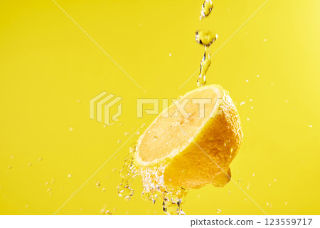 Halved lemon and water splashes Halved lemon and water splashes 123559717