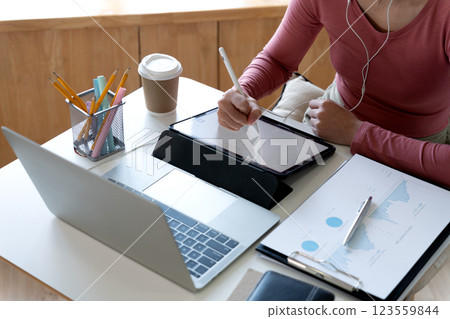 young woman student is working intently using a tablet notebook young woman student is working intently using a tablet notebook 123559844
