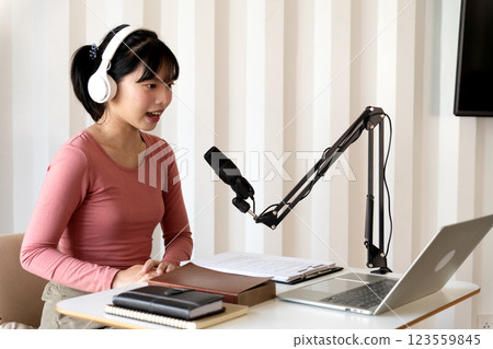 young woman is broadcasting with a microphone expressing herself young woman is broadcasting with a microphone expressing herself 123559845