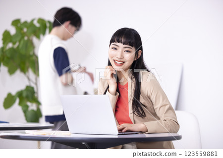 Business: Young woman looking at a computer Business: Young woman looking at a computer 123559881