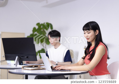 Business: Young woman looking at a computer 123559889