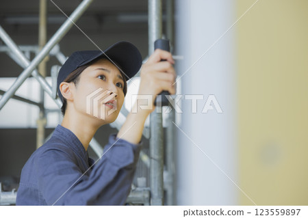 A woman working at a construction site A woman working at a construction site 123559897