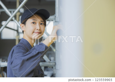 A woman working at a construction site 123559903