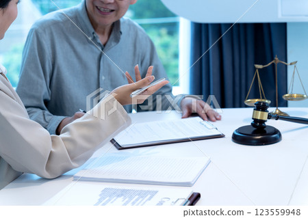 Lawyer and client are listening and giving advice about a legal case Lawyer and client are listening and giving advice about a legal case 123559948