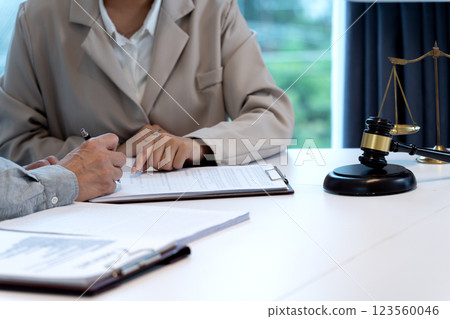 lawyer points out a document for his client to sign a legal document lawyer points out a document for his client to sign a legal document 123560046