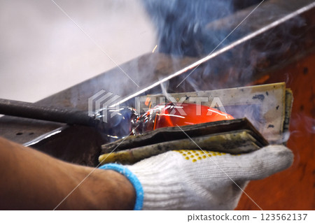 Shaping blown glass at the Satsuma Kiriko Glass Factory 123562137