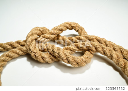 Closeup view of ropes string with a knot isolated over a white background Closeup view of ropes string with a knot isolated over a white background 123563532