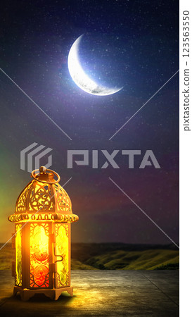 Traditional glowing Arabic lantern with crescent moon view on night scene background. Copy space or mockup. Concept of Eid Al Fitr and Ramadan Mubarak. Islamic background Traditional glowing Arabic lantern with crescent moon view on night scene background. Copy space or mockup. Concept of Eid Al Fitr and Ramadan Mubarak. Islamic background 123563550