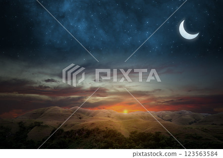 Islamic night sunset with view of landscape and crescent moon. Hilal at night with some clouds in the sky. Copy space or mockup. Concept of Eid Al Fitr and Ramadan Mubarak. Ramadan kareem background 123563584