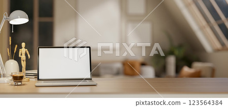 A white screen laptop on wooden table under the lamp light and moon light. Study or working at night. 123564384