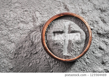 Cross imprint in gray ash bowl on ash background. Ash Wednesday 123564489