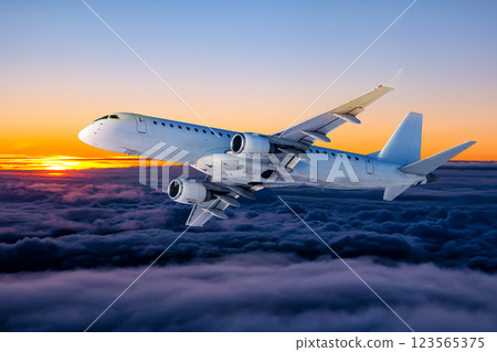 White passenger aircraft fly in the sunset sky White passenger aircraft fly in the sunset sky 123565375