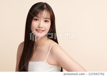 Beautiful young asian woman with clean fresh skin on beige background, Face care, Facial treatment, Cosmetology, beauty and spa, Asian women portrait. Beautiful young asian woman with clean fresh skin on beige background, Face care, Facial treatment, Cosmetology, beauty and spa, Asian women portrait. 123565792