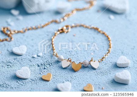Close up of a charm bracelet with initials and hearts, perfect for personalized Valentine gifts 123565946