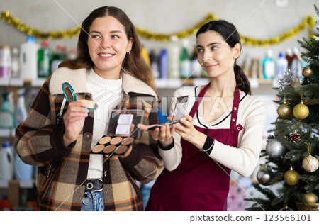 saleswoman offers a customer cosmetics for Christmas saleswoman offers a customer cosmetics for Christmas 123566101